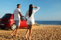 Happy couple walking on sandy beach. Summer trip Royalty Free Stock Photo