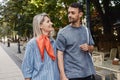 Happy couple walking together on an urban street in daylight Royalty Free Stock Photo