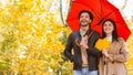 Happy ouple walking under umbrella at rainy autumn day Royalty Free Stock Photo