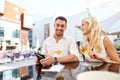 Happy couple with wallet paying bill at restaurant Royalty Free Stock Photo