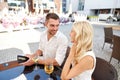 Happy couple with wallet paying bill at restaurant Royalty Free Stock Photo