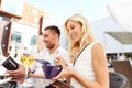 Happy couple with wallet paying bill at restaurant Royalty Free Stock Photo