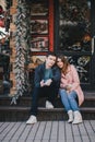 Happy couple in warm clothes drinking coffee on a Christmas market Royalty Free Stock Photo