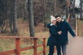 happy couple in warm knitted hat and scarf walking outdoor in autumn forest Royalty Free Stock Photo