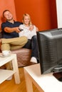 Happy couple watching television together relaxing sofa Royalty Free Stock Photo