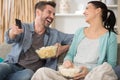 happy couple watching tv and eating pop-corn Royalty Free Stock Photo