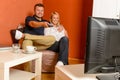 Happy couple watching tv evening changing channels Royalty Free Stock Photo