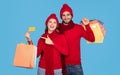 Happy Couple Wearing Winter Hats Posing With Credit Card And Shopping Bags Royalty Free Stock Photo