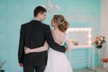 Happy couple. Wedding photo shoot in the white studio with wedding decor kisses, hugs