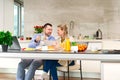 Happy couple working from home and having breakfast together. Breakfast together before leaving for work. Royalty Free Stock Photo