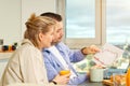 Happy couple working from home and having breakfast together. Breakfast together before leaving for work. Royalty Free Stock Photo