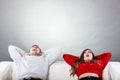 Happy couple yawning resting on couch at home. Royalty Free Stock Photo