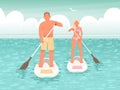 Happy couple of young people swim on stand up paddle board. A man and a woman hold oars in their hands Royalty Free Stock Photo