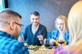 Happy couples having fun while enjoying lunch at fast food restaurant Royalty Free Stock Photo