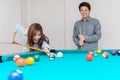 Happy couples are playing billiards in home,