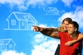 Happy coupleunder the blue sky dreaming of a house. Royalty Free Stock Photo