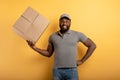 Happy courier with a box to deliver. emotional expression. Yellow background