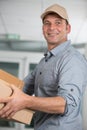 happy courier man with holding boxes