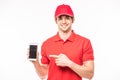 Happy courier with phone looking at camera isolated white background