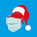 Happy Covid Christmas, coronavirus wearing a santa hat and mask on a blue background