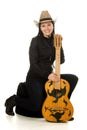 Happy cowgirl in ahat with acoustic guitar Royalty Free Stock Photo