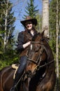 Happy cowgirl on brown horse Royalty Free Stock Photo
