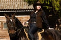 Happy cowgirl on brown horse Royalty Free Stock Photo