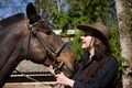 Happy cowgirl with brown horse Royalty Free Stock Photo