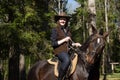 Happy cowgirl on brown horse Royalty Free Stock Photo