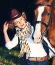 Happy cowgirl with her red horse. Royalty Free Stock Photo