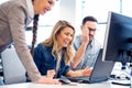 Happy coworkers analyzing final version of the project before a Royalty Free Stock Photo