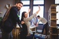 Happy coworkers enjoying by desk in creative office Royalty Free Stock Photo