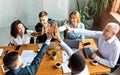 Happy Coworkers Giving High-Five Celebrating Business Success Sitting In Office Royalty Free Stock Photo