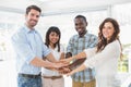 Happy coworkers joining hands in a circle Royalty Free Stock Photo