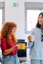 Happy coworkers laughing while enjoying a coffee break in the office. Royalty Free Stock Photo