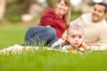 Happy Crawling Baby Boy and Mixed Race Parents Playing in the Park