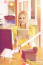 Happy creative female office worker with tablet pc Royalty Free Stock Photo