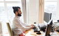 Happy creative male office worker with computer