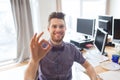 Happy creative male office worker showing ok sign