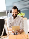 Happy creative male office worker with tablet pc Royalty Free Stock Photo