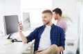 Happy creative man texting on cellphone at office Royalty Free Stock Photo