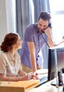 Happy creative team calling on phone in office Royalty Free Stock Photo