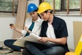 Happy Creative young Asian couple renovating house together and using a blueprint for renovation planning and how to   decorate Royalty Free Stock Photo