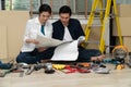 Happy Creative young Asian couple renovating house together and using a blueprint for renovation planning and how to   decorate Royalty Free Stock Photo