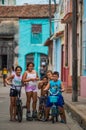 Happy Cuban boy and girl capture portrait in poor colorful colonial alley with smile face, in Camaguey, Cuba, America.