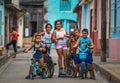 Happy Cuban children portrait in poor colorful colonial street alley with smile face, in old city, Cuba, America.