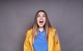 A happy curious excited woman is looking up, with a joyful expression on her face