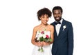 Curly african american bride smiling while holding bouquet near bridegroom isolated on white Royalty Free Stock Photo