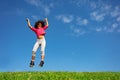 Happy curly hair girl jump over blue sky hands up Royalty Free Stock Photo