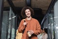 happy and curly man with paper